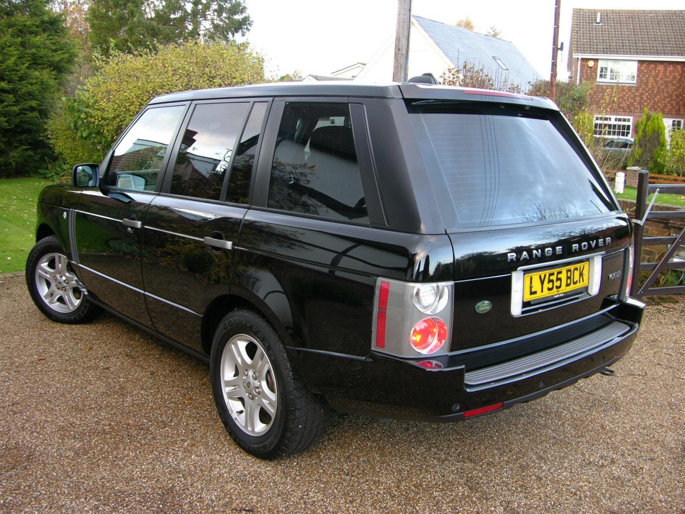 Rear and side profile of a black luxury SUV with tinted windows and distinctive taillights