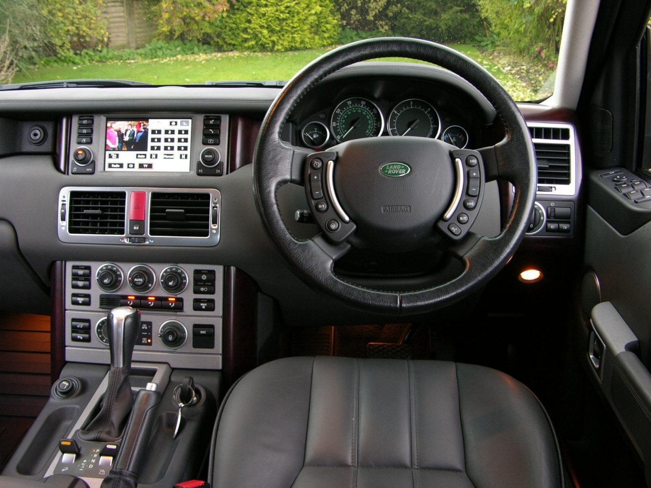 Steering wheel and dashboard with multimedia display and center console controls