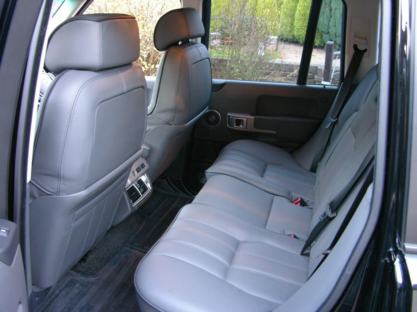 Luxury rear leather seats with climate control vents in spacious rear cabin