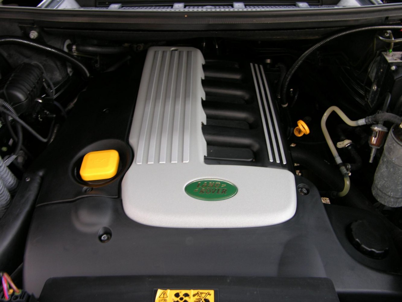 Engine bay with distinctive engine cover and components