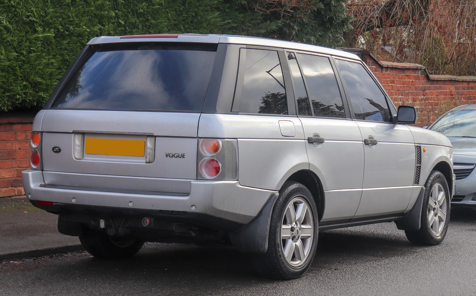 Rear view of mid-size luxury SUV with distinctive taillights and tinted rear windows.