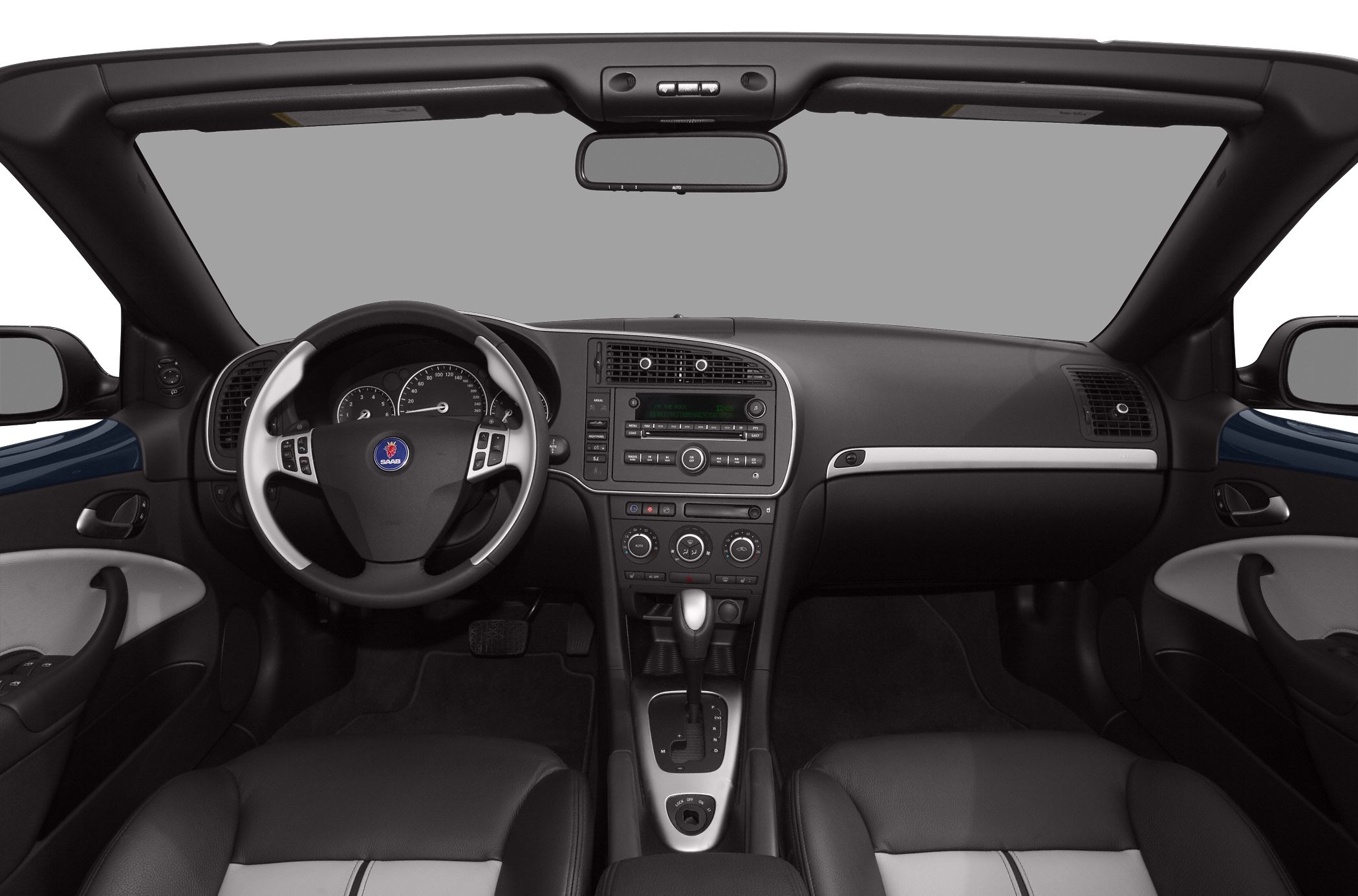 Dashboard and interior of a convertible with steering wheel and center console