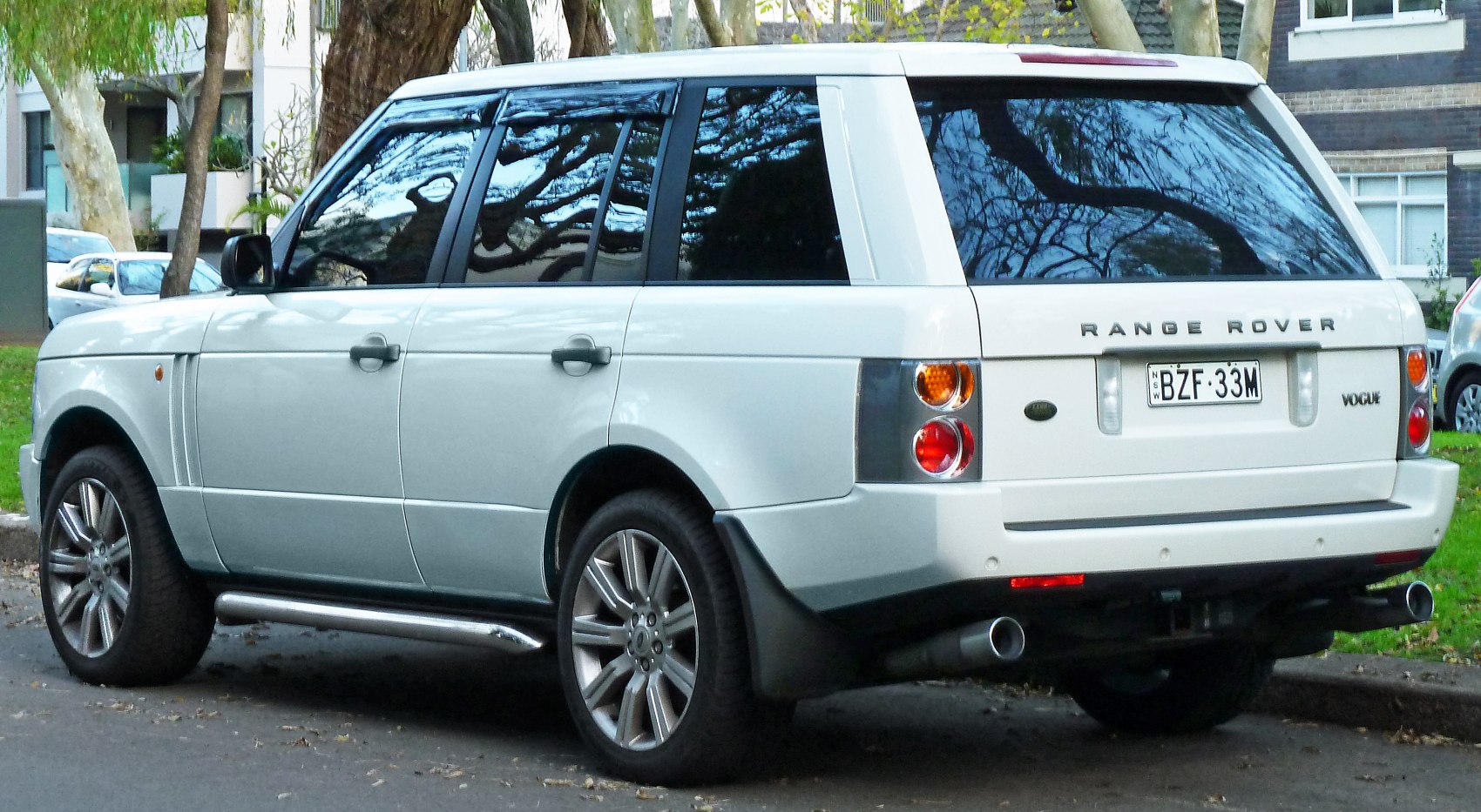 Rear side view with dual exhaust and alloy wheels
