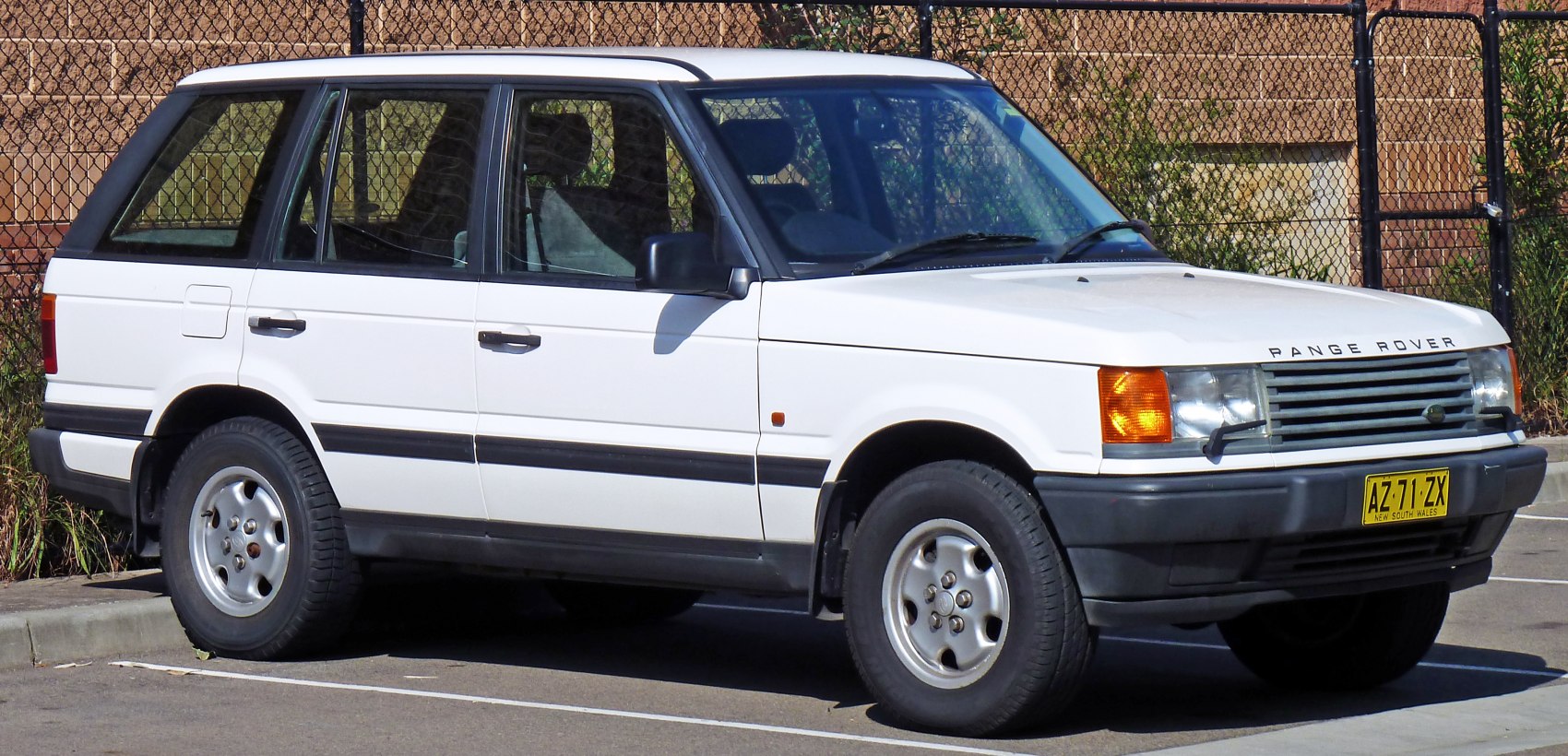 Front-side view of a 1990s boxy SUV with distinctive grille and wheels