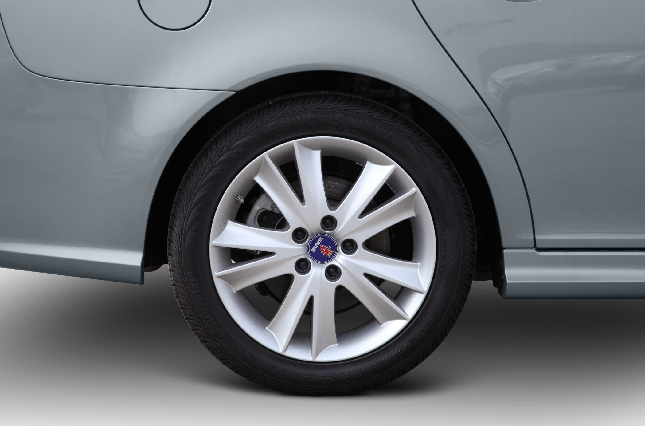 Close-up of alloy wheel and tire with Saab logo