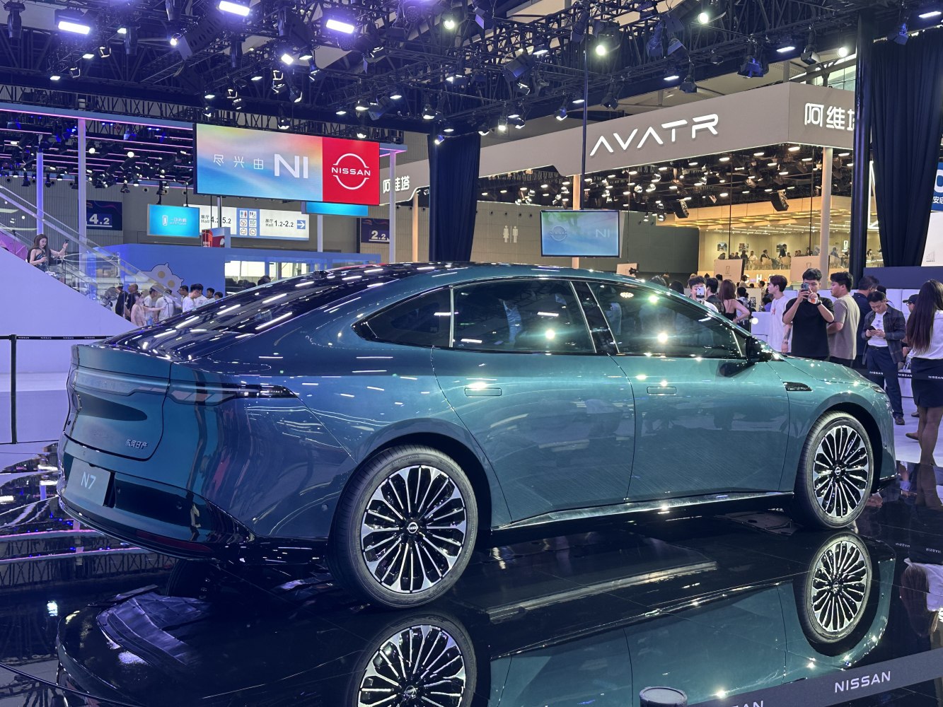 Rear side view of sleek sedan with full-width LED tail light and stylish wheels