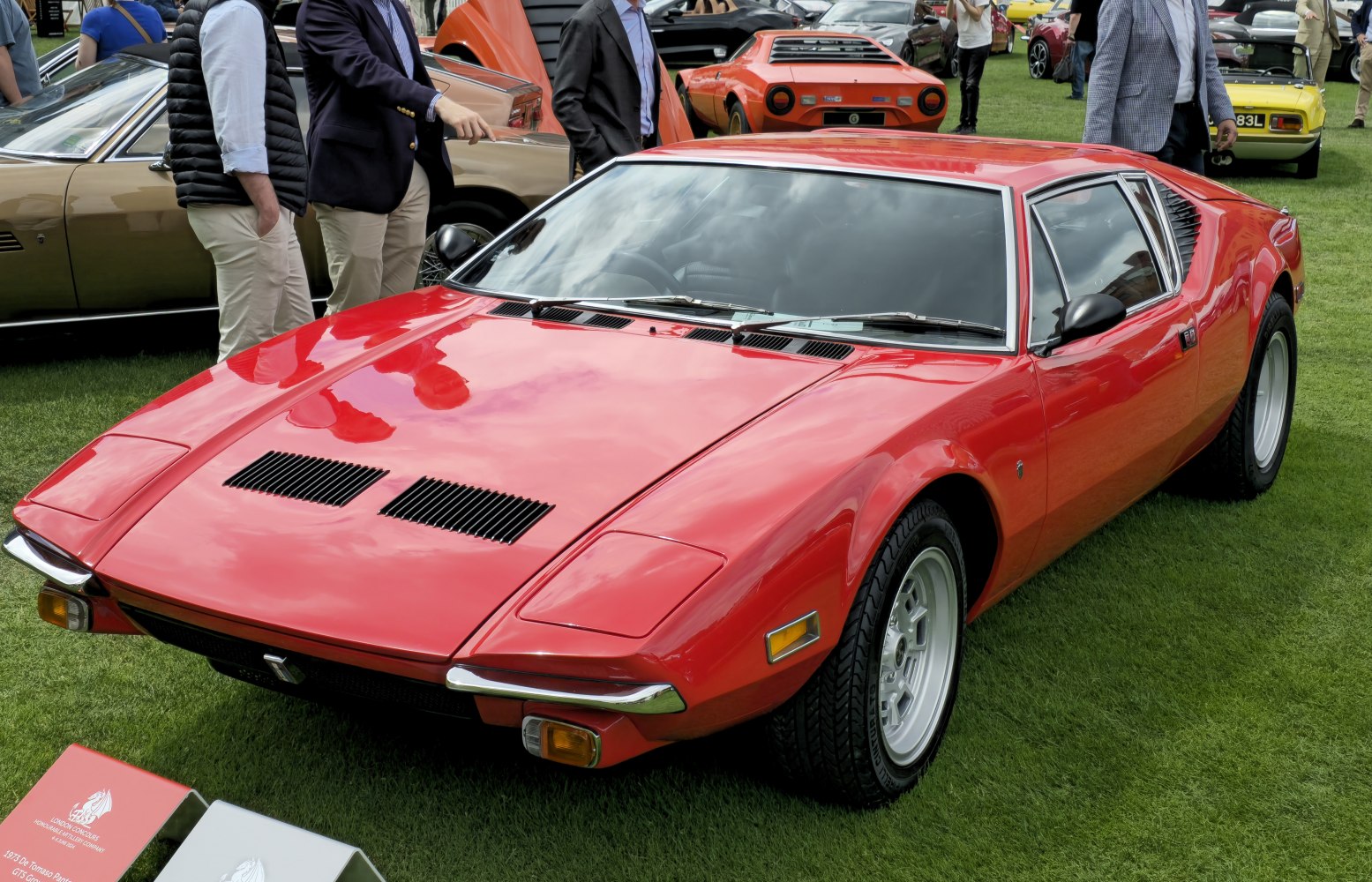 Low-profile sports coupe with front hood vents and wide alloy wheels