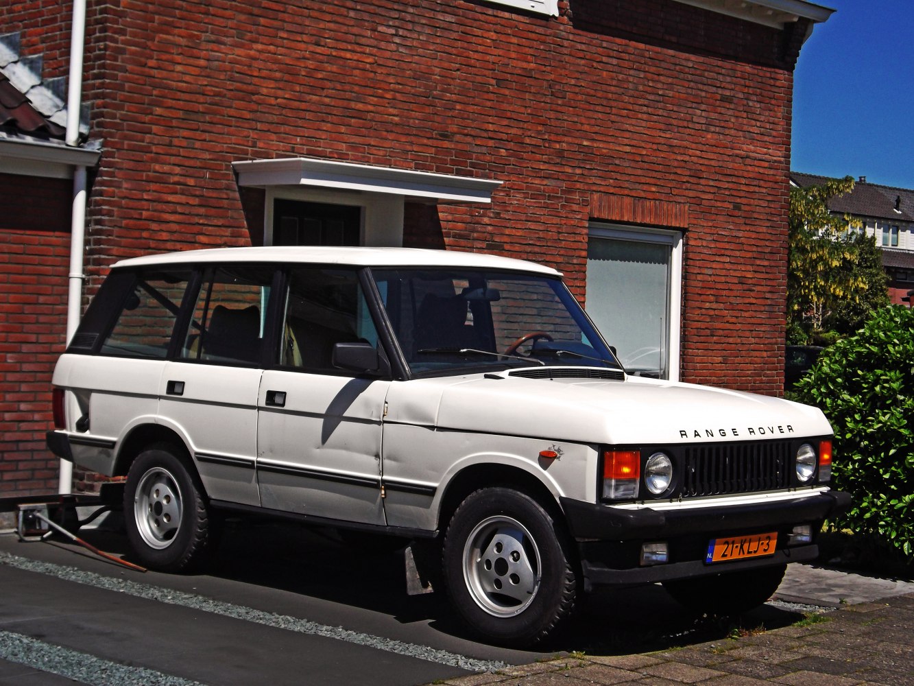Boxy white vintage SUV with classic front side profile