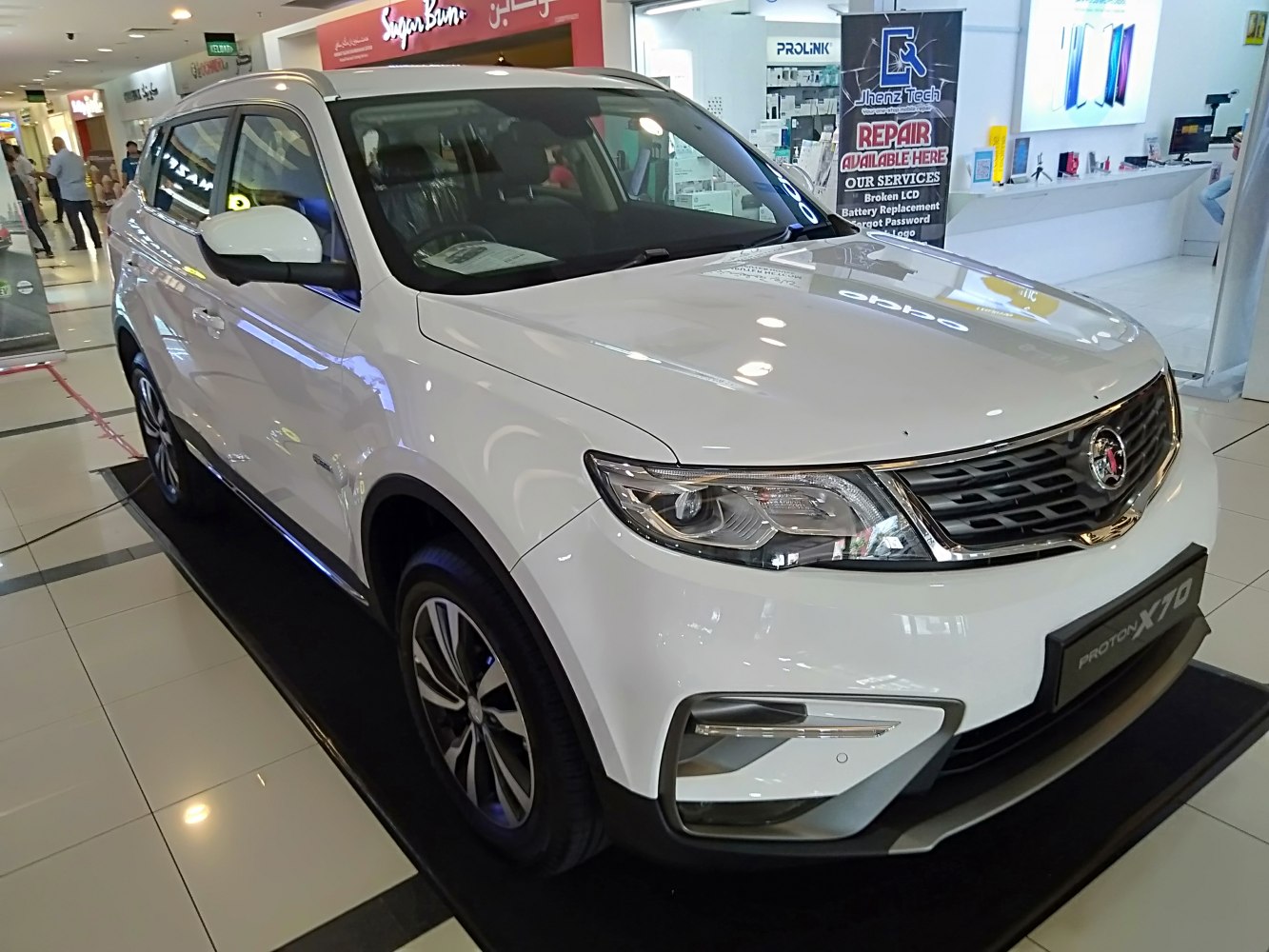 Front angle of white SUV with modern headlights and distinctive grille.