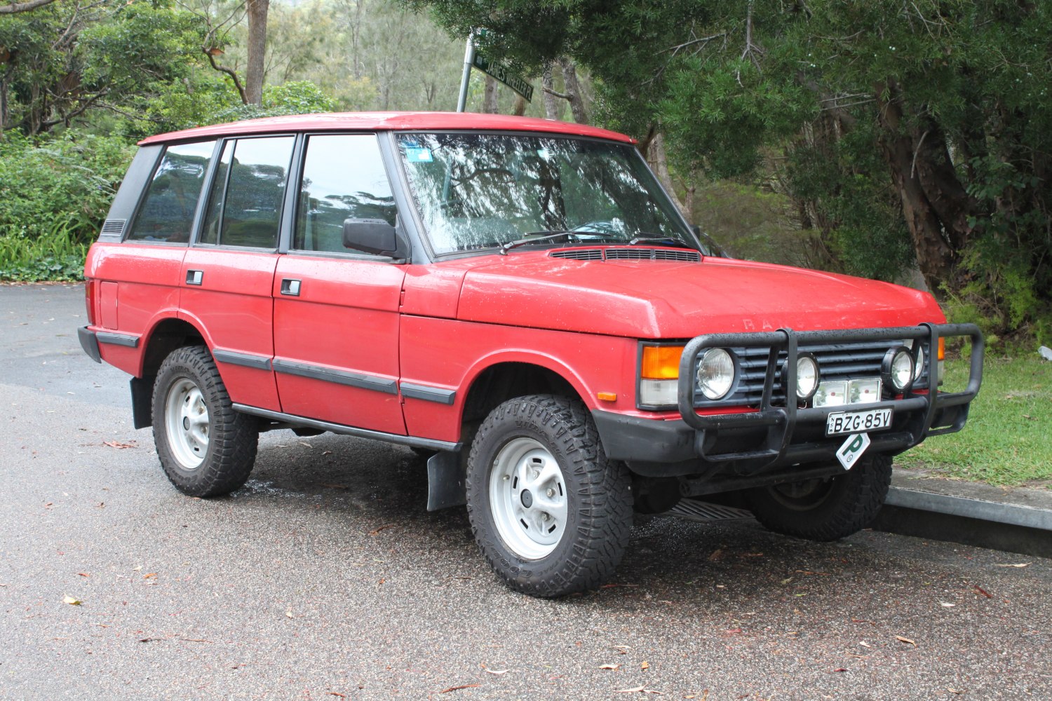 Vintage rugged SUV with front bull bar and all-terrain tires