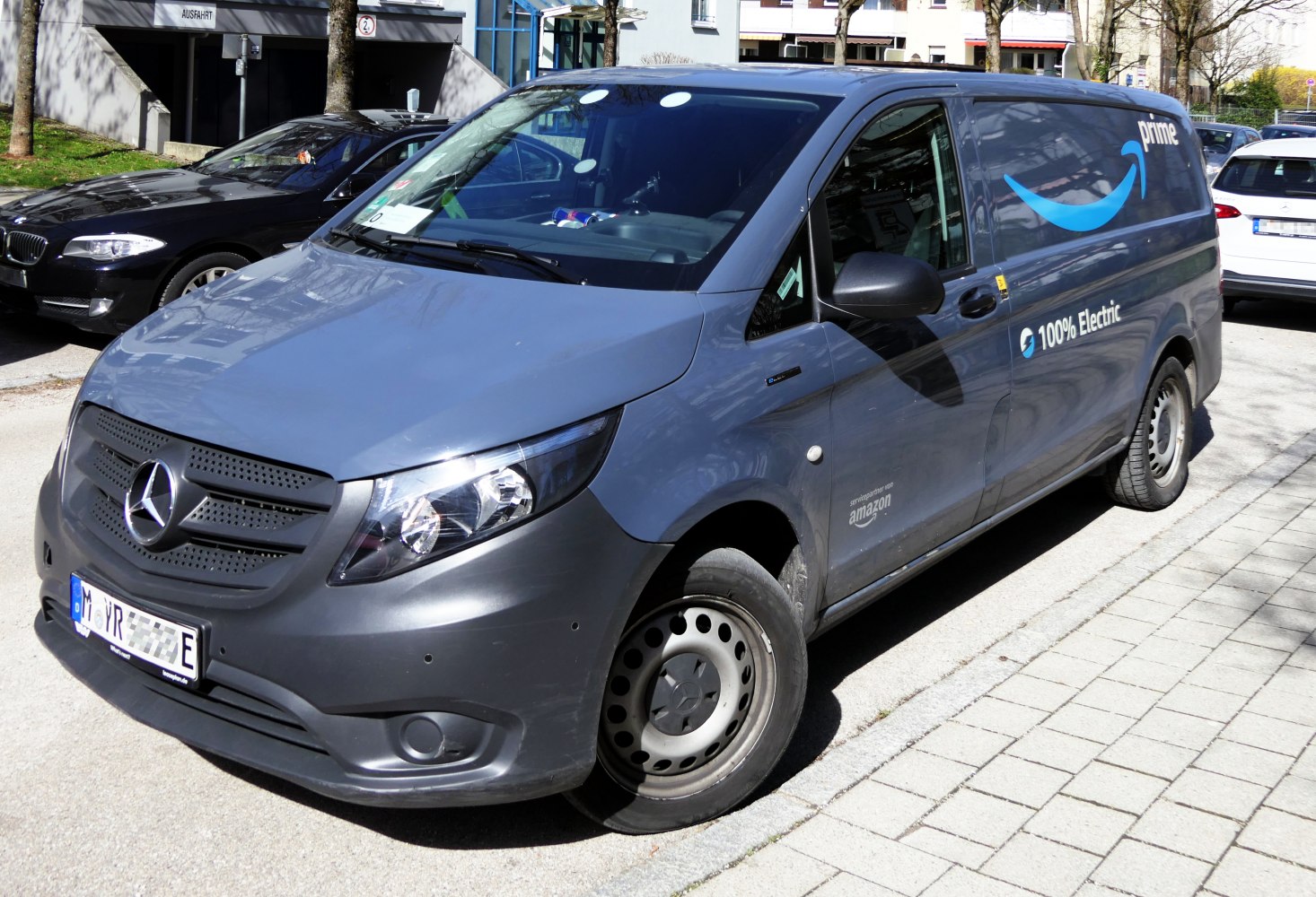 Electric long wheelbase delivery van with Amazon Prime branding and 100% electric badge