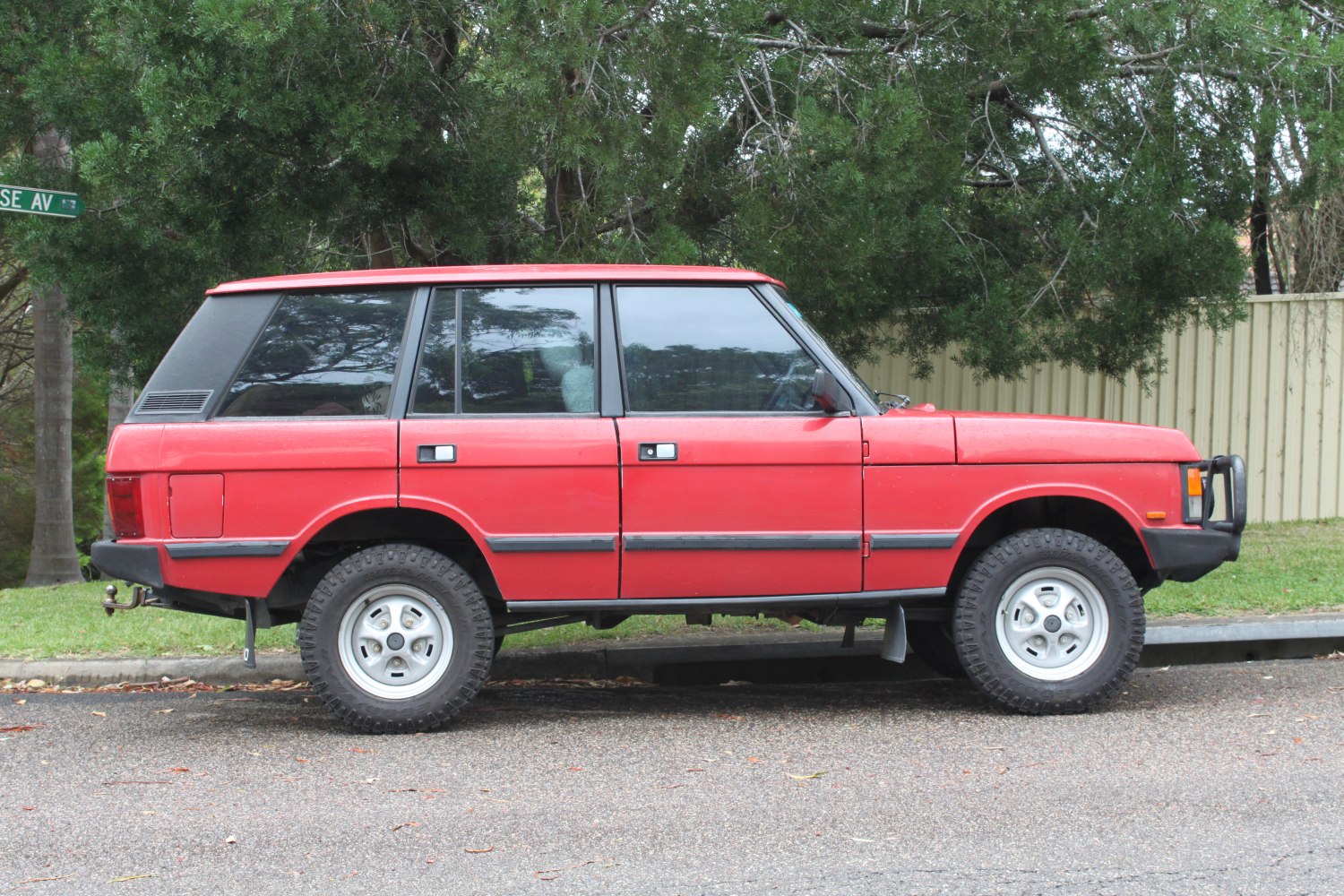 Boxy red SUV with off-road tires and rugged styling