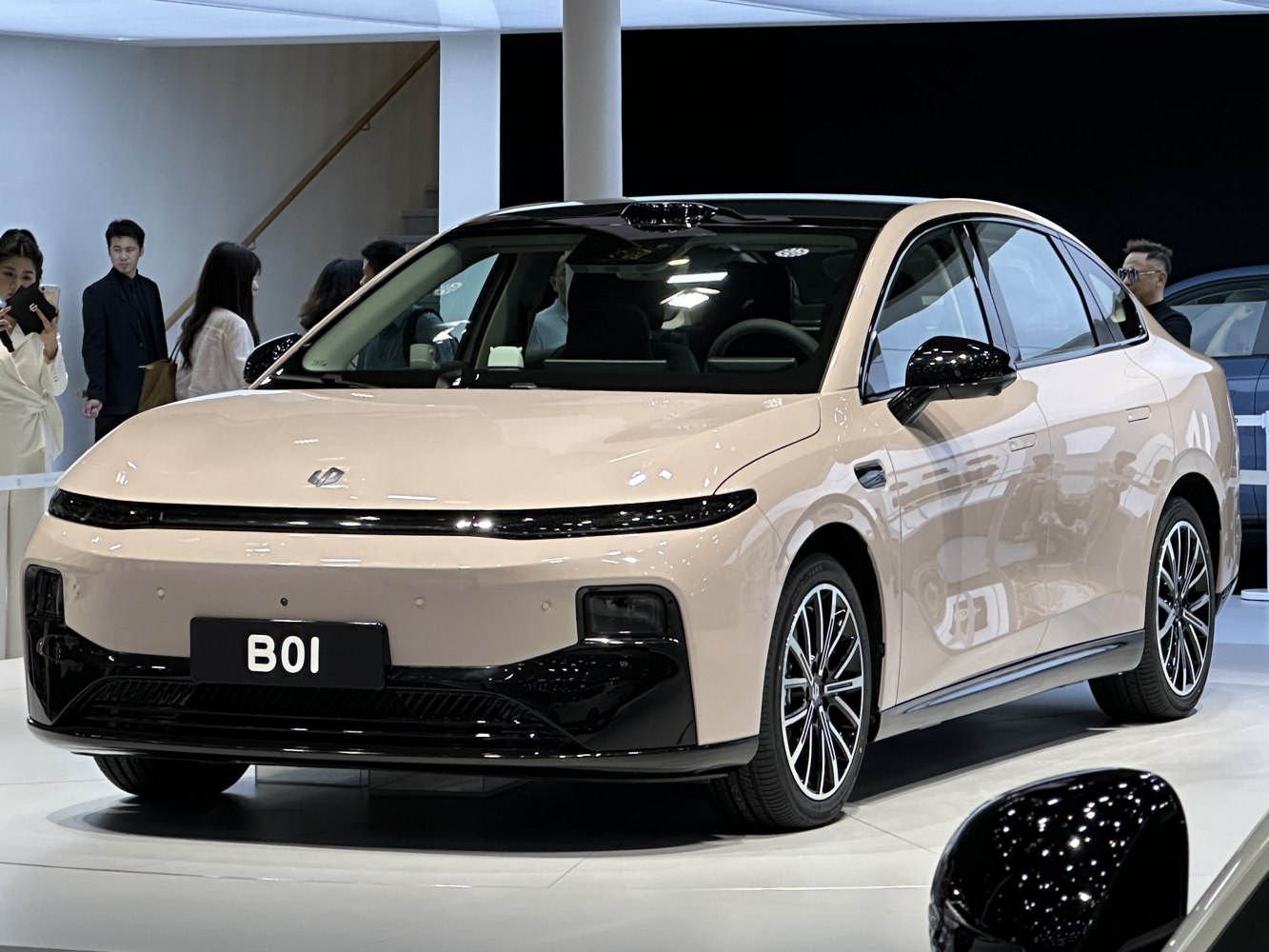 Sleek front fascia with integrated LED light bar and aerodynamic coupe-like sedan design.