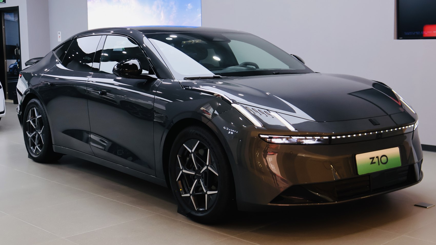 Futuristic electric sedan with aerodynamic body and distinctive LED lighting