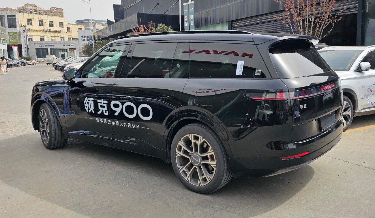 Rear side profile of large SUV with modern taillights and alloy wheels