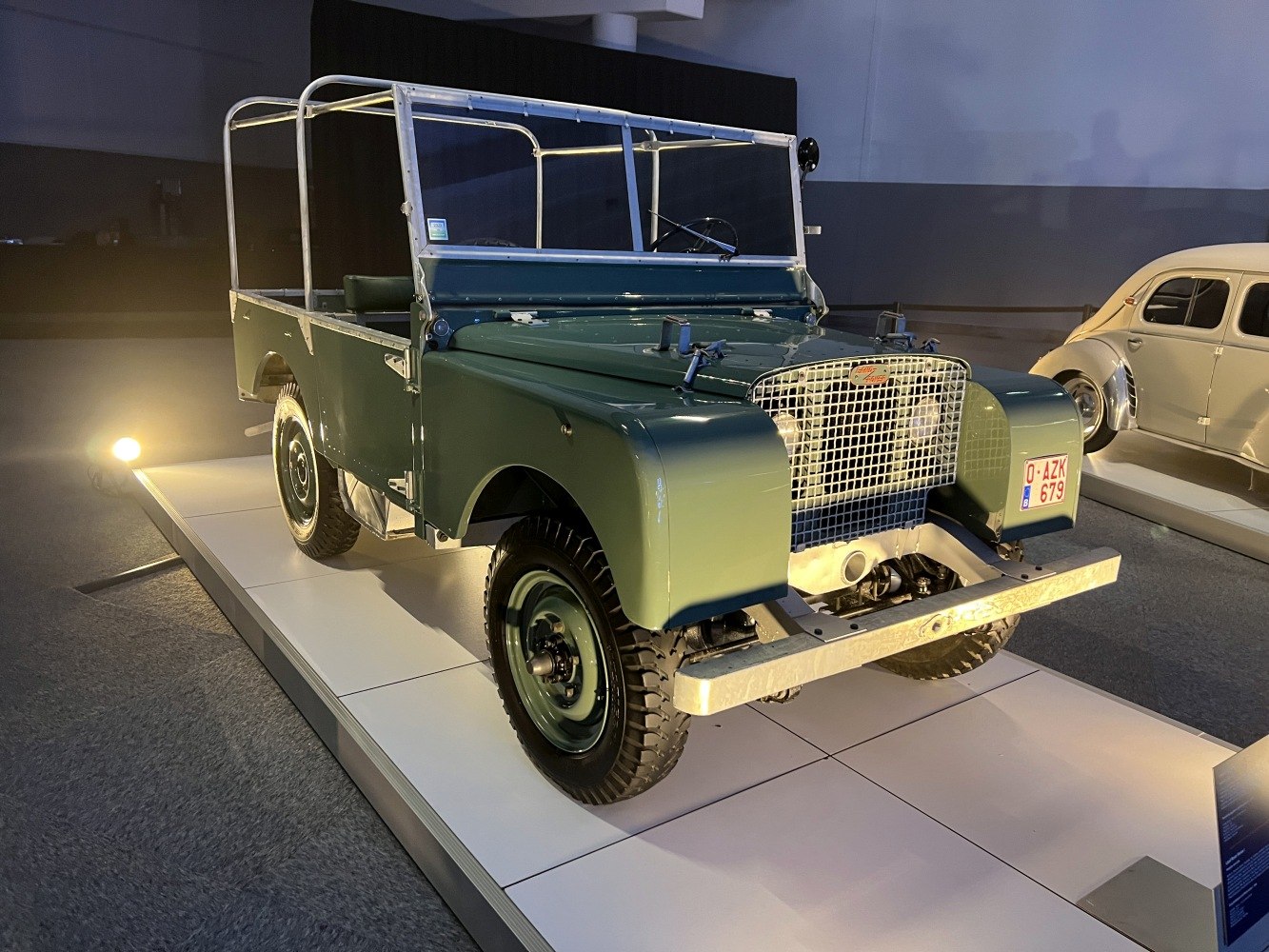 Open-frame off-road vehicle with mesh front grille and durable metal bumper.