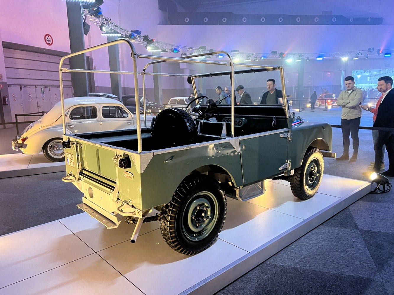 Open-top off-road vehicle with rear spare tire and roll cage frame