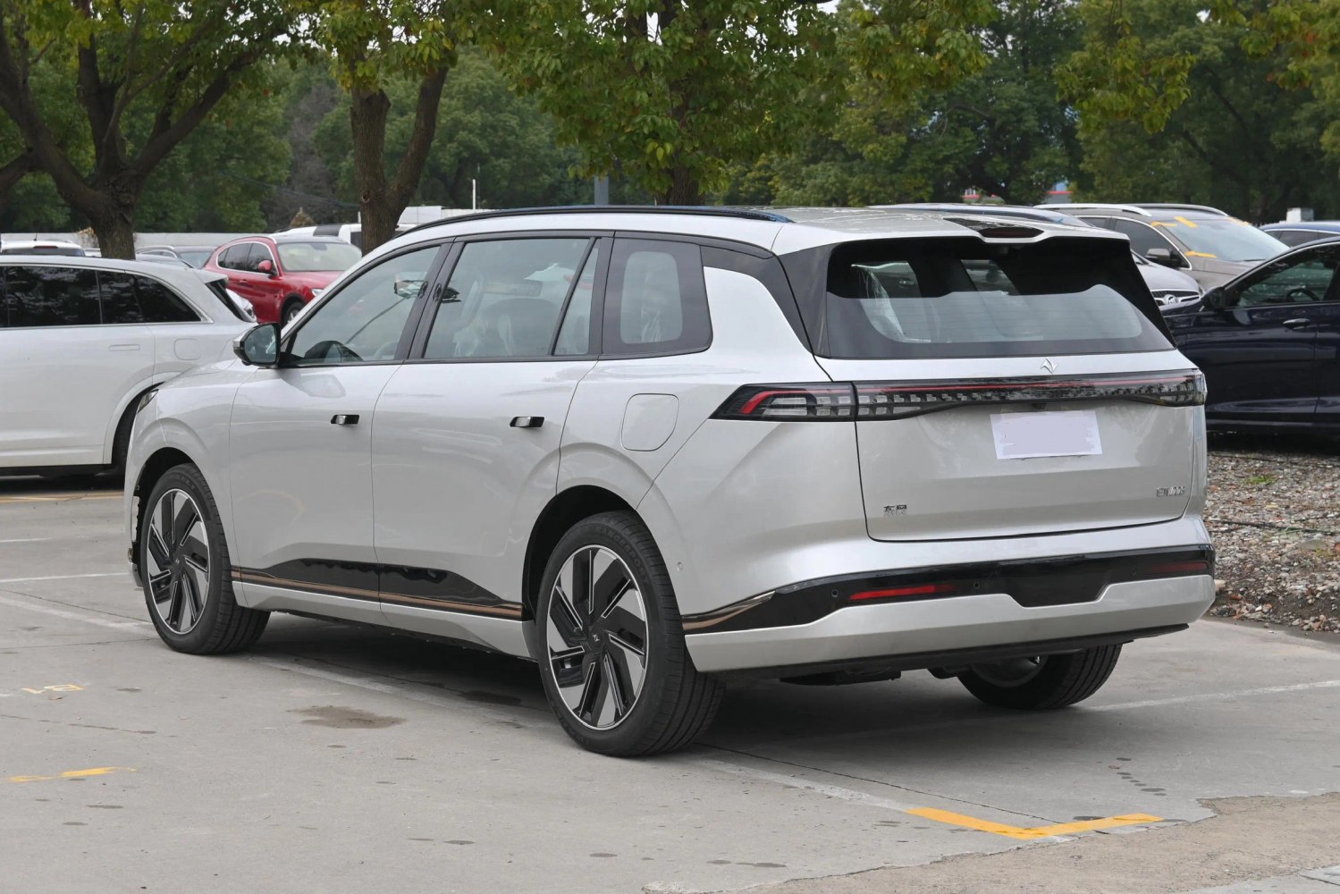 Sleek rear and side view of modern electric SUV with aerodynamic wheels and futuristic lighting