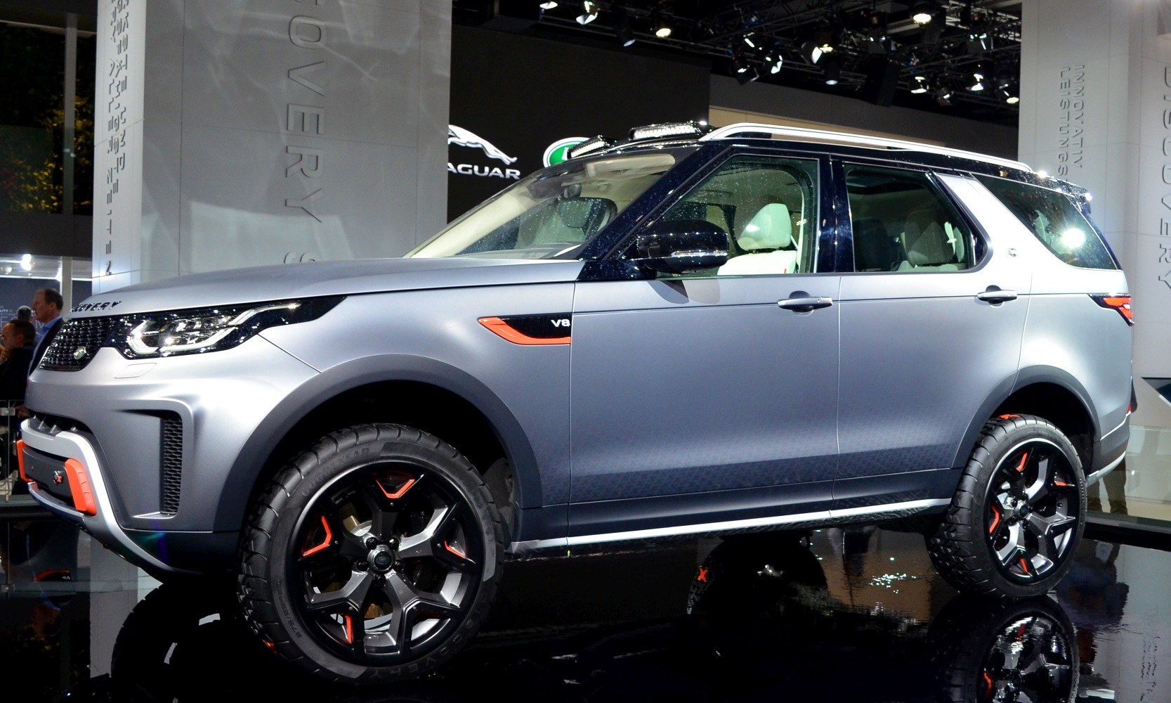 Side profile of SUV with V8 badge and custom alloy wheels with orange highlights