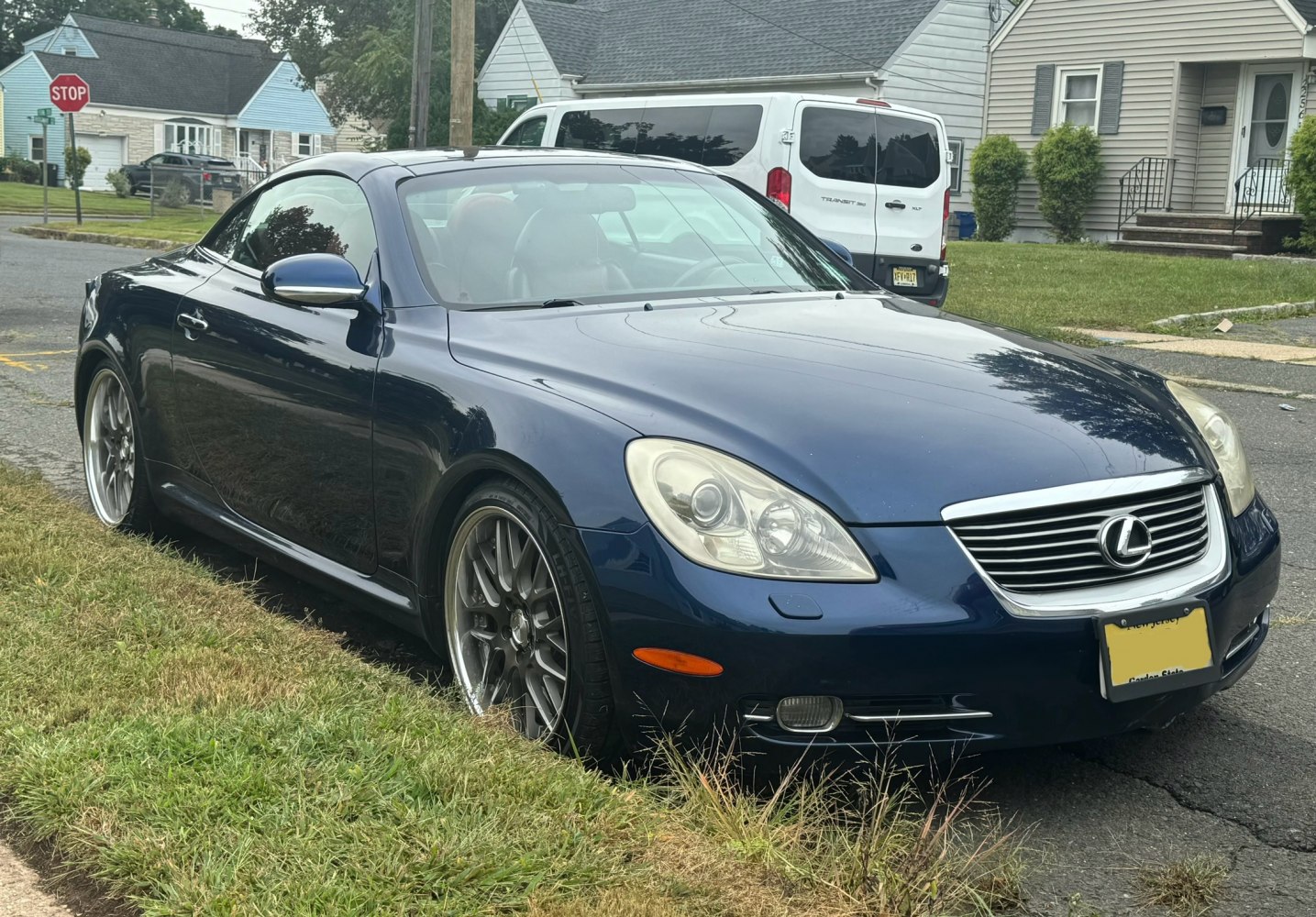 Front side view of convertible coupe with sleek headlights and sporty wheels