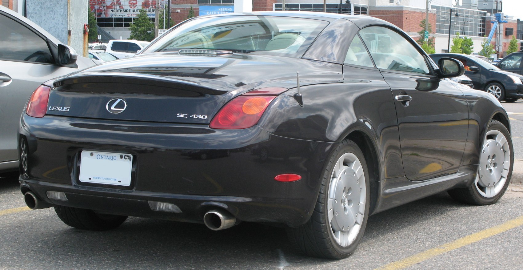 Rear view of luxury coupe with distinctive taillights and dual exhaust pipes