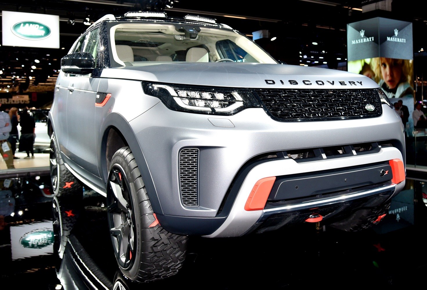 Front grille and LED headlights of modern SUV with off-road tires