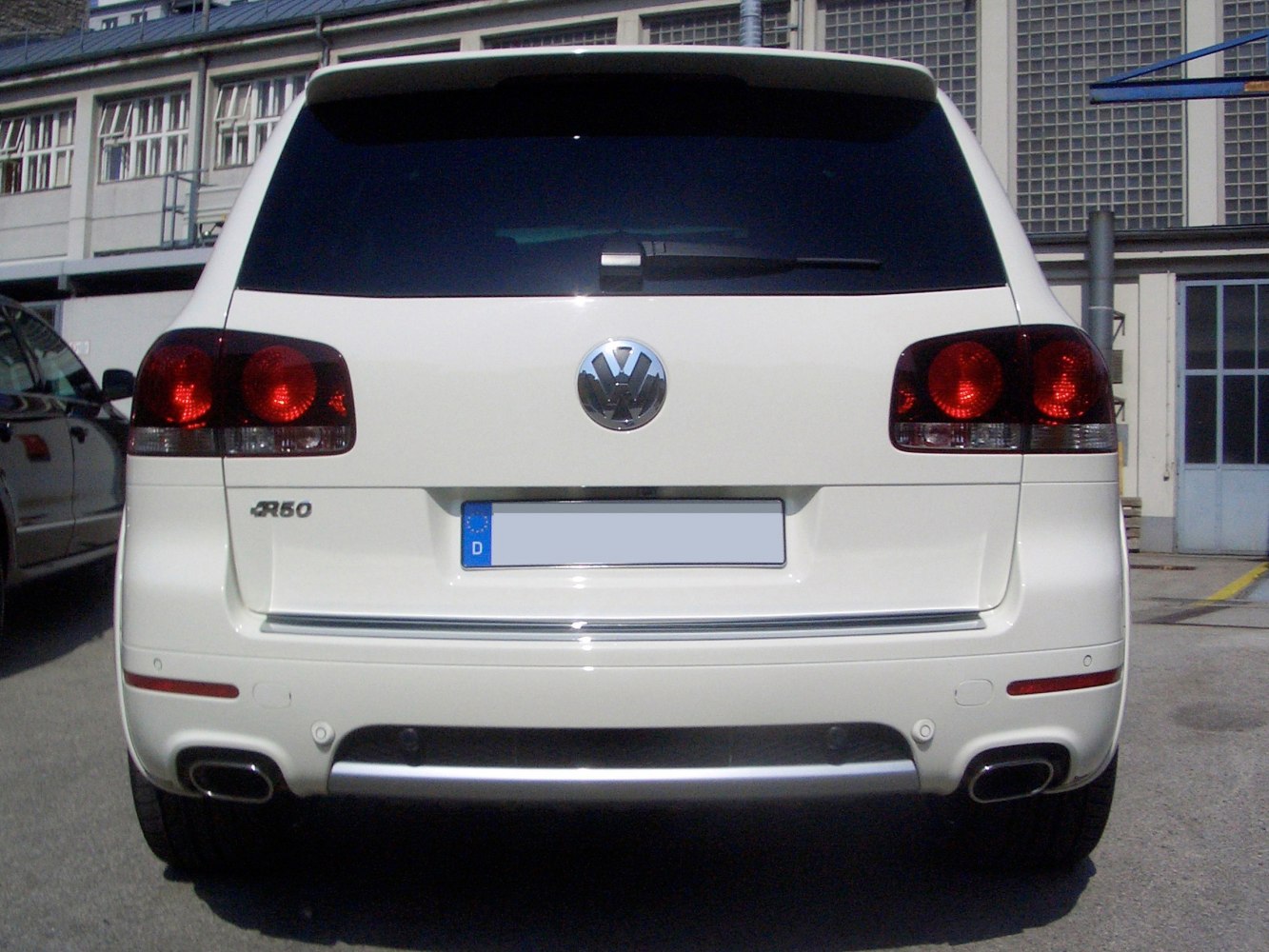 Rear view with dark taillights and dual exhaust outlets
