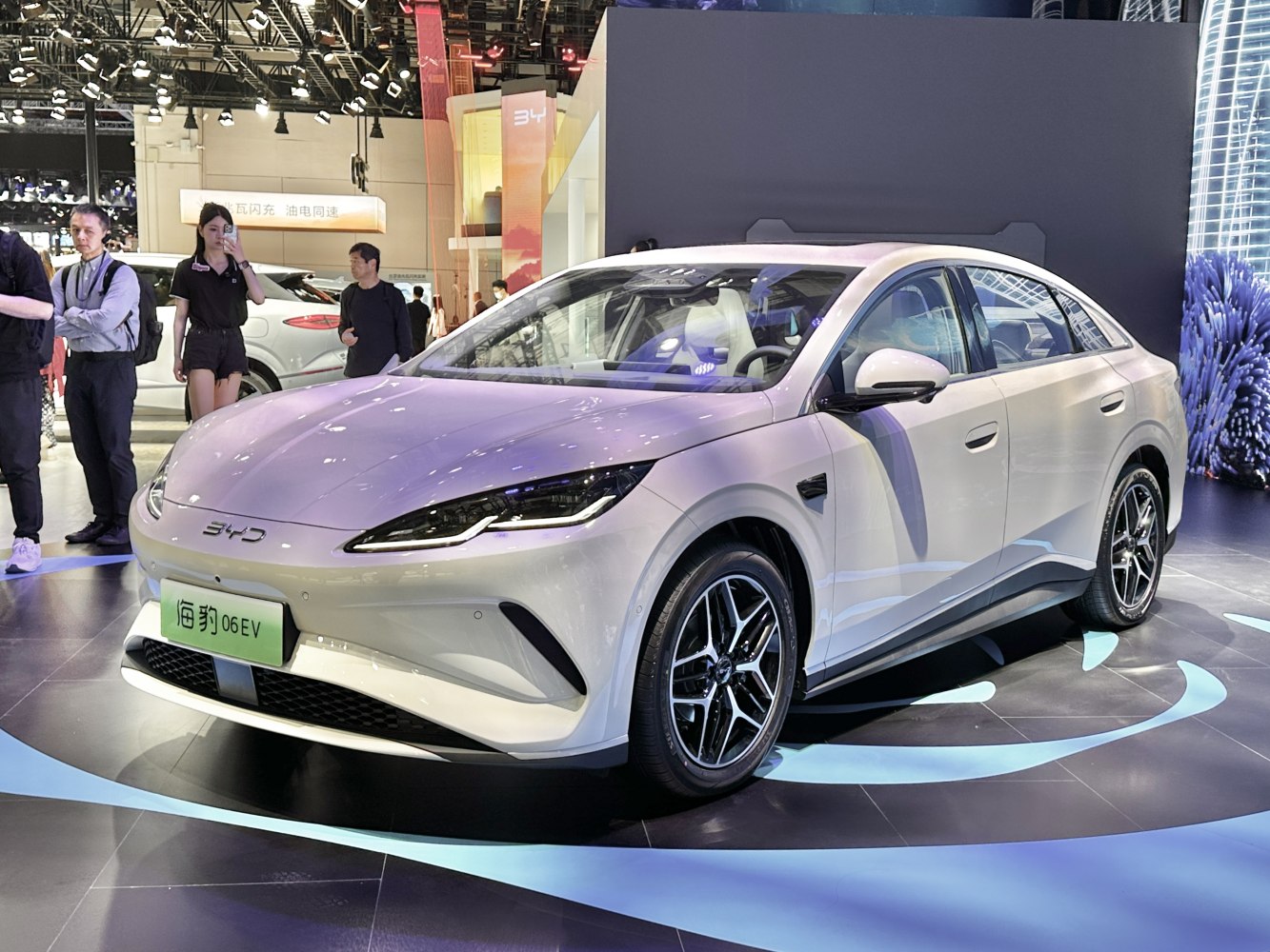 Front angled view of electric sedan with sleek headlights and aerodynamic design