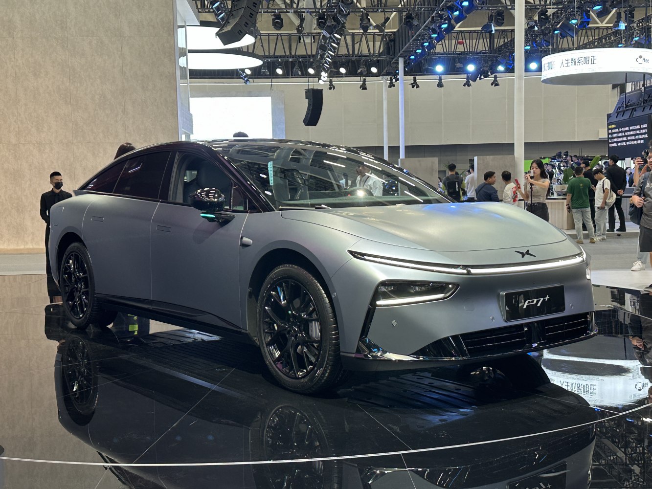 Electric sedan with narrow LED headlights and black alloy wheels.