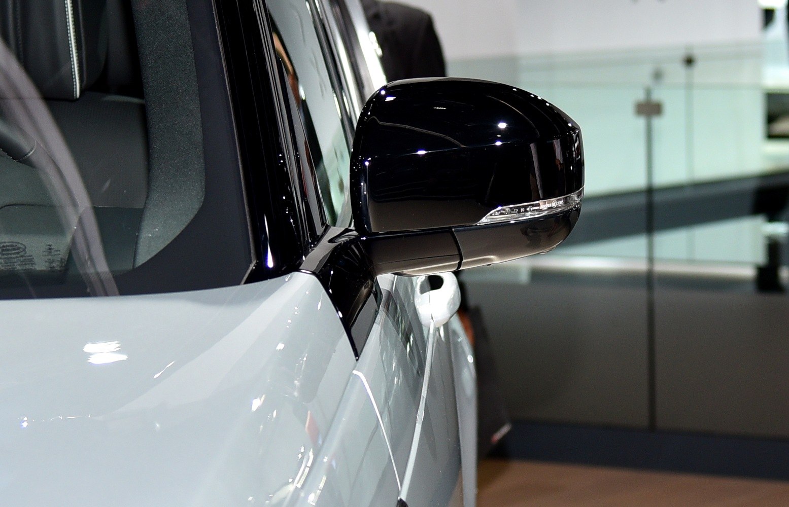 Close-up of a sleek side mirror on a vehicle door