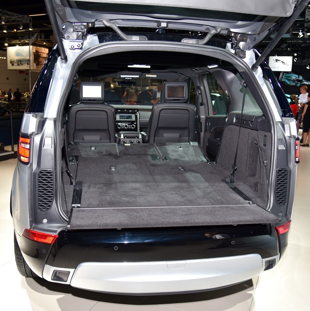 SUV cargo area with folded rear seats and rear entertainment screens