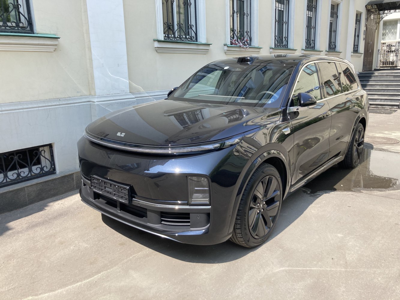 Front and side of sleek black electric SUV with LED strip lighting