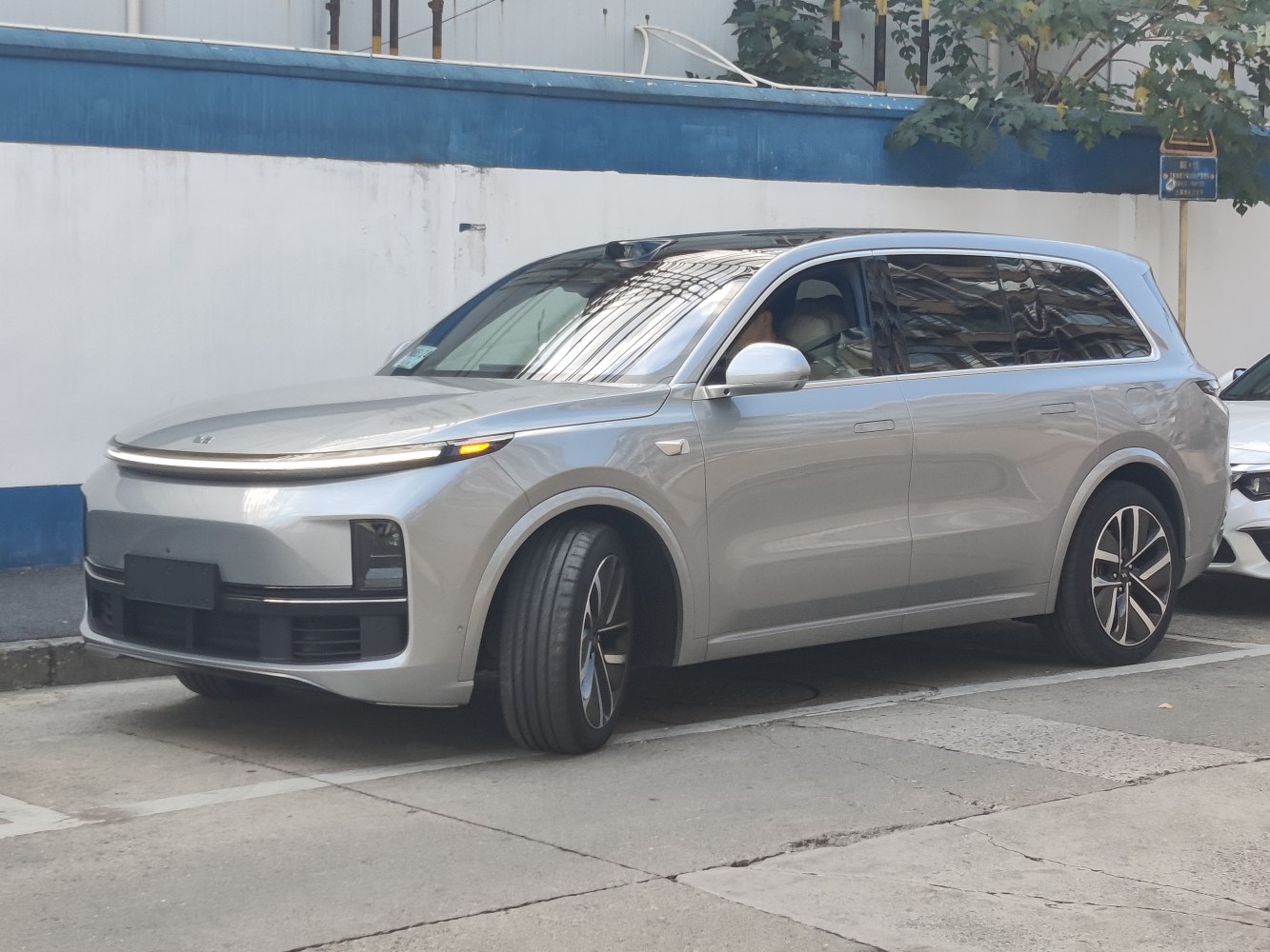 Front and side view of a silver modern electric SUV