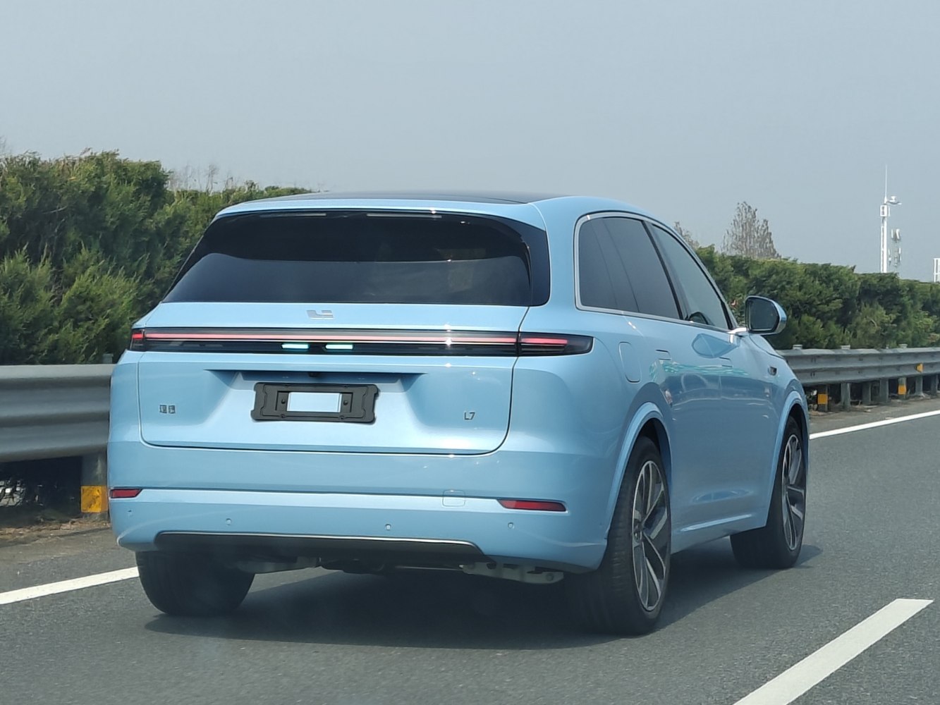 Rear view with LED light bar and aerodynamic shape on a blue SUV