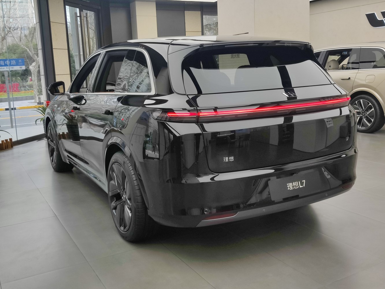 Sleek black SUV rear with continuous LED tail light strip and aerodynamic shape