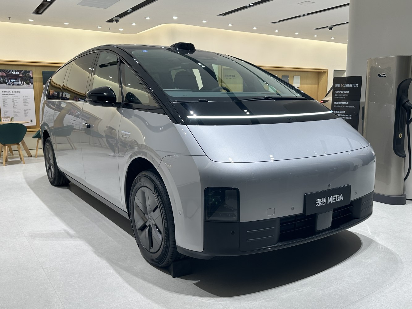 Sleek electric minivan with digital strip front lighting and aerodynamic design