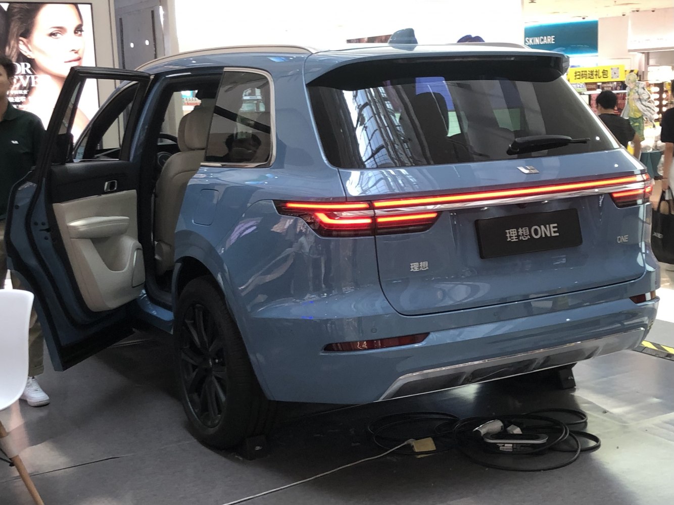 Rear view with LED light bar and open rear door of an electric SUV