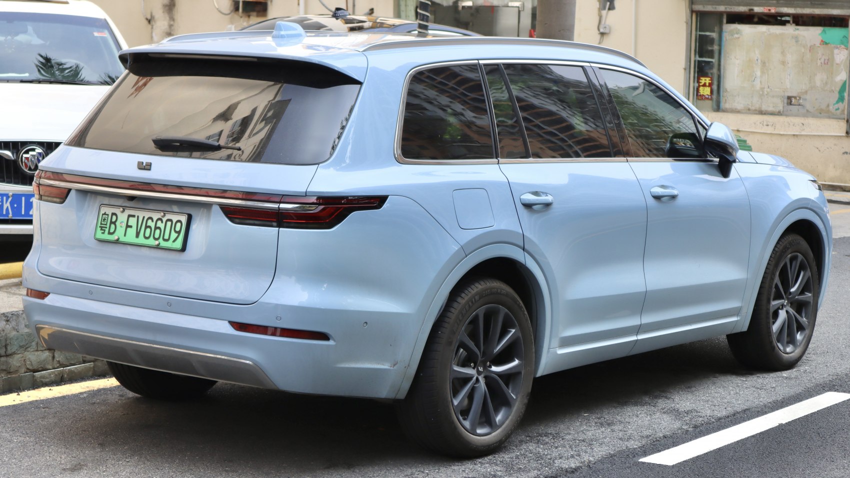 SUV rear and side view with continuous tail lights and tinted windows
