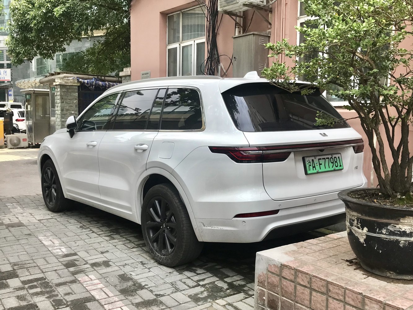 Rear side view of a white modern SUV with sleek taillights and tinted windows