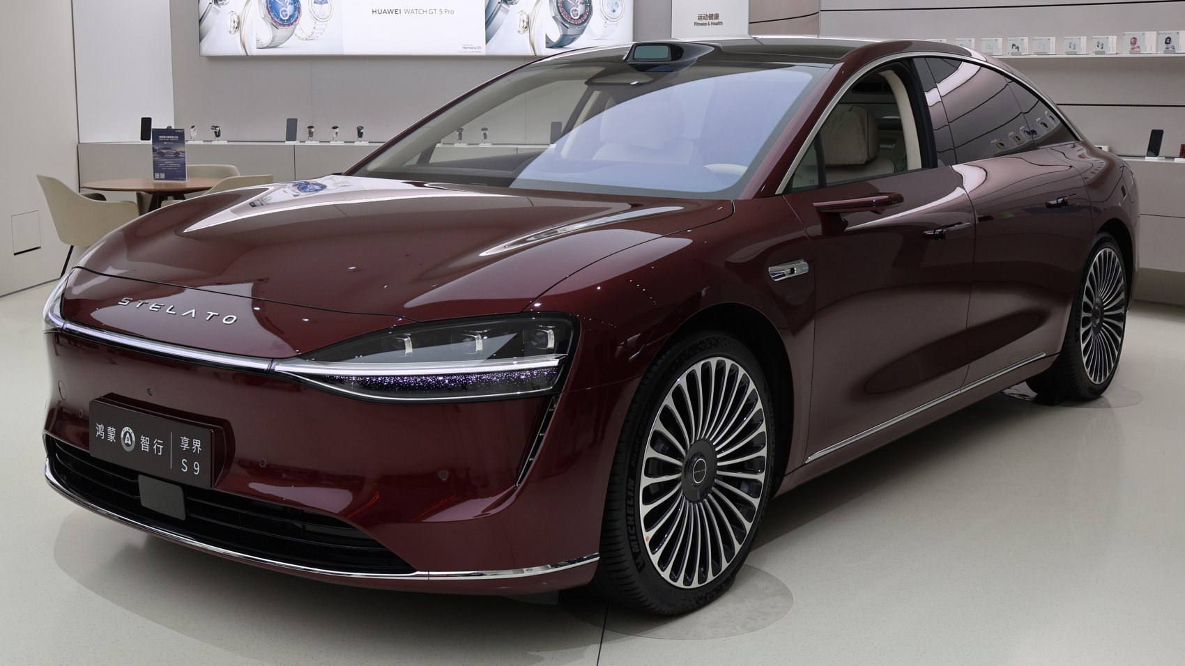 Sleek electric sedan front with advanced headlights and multi-spoke wheels