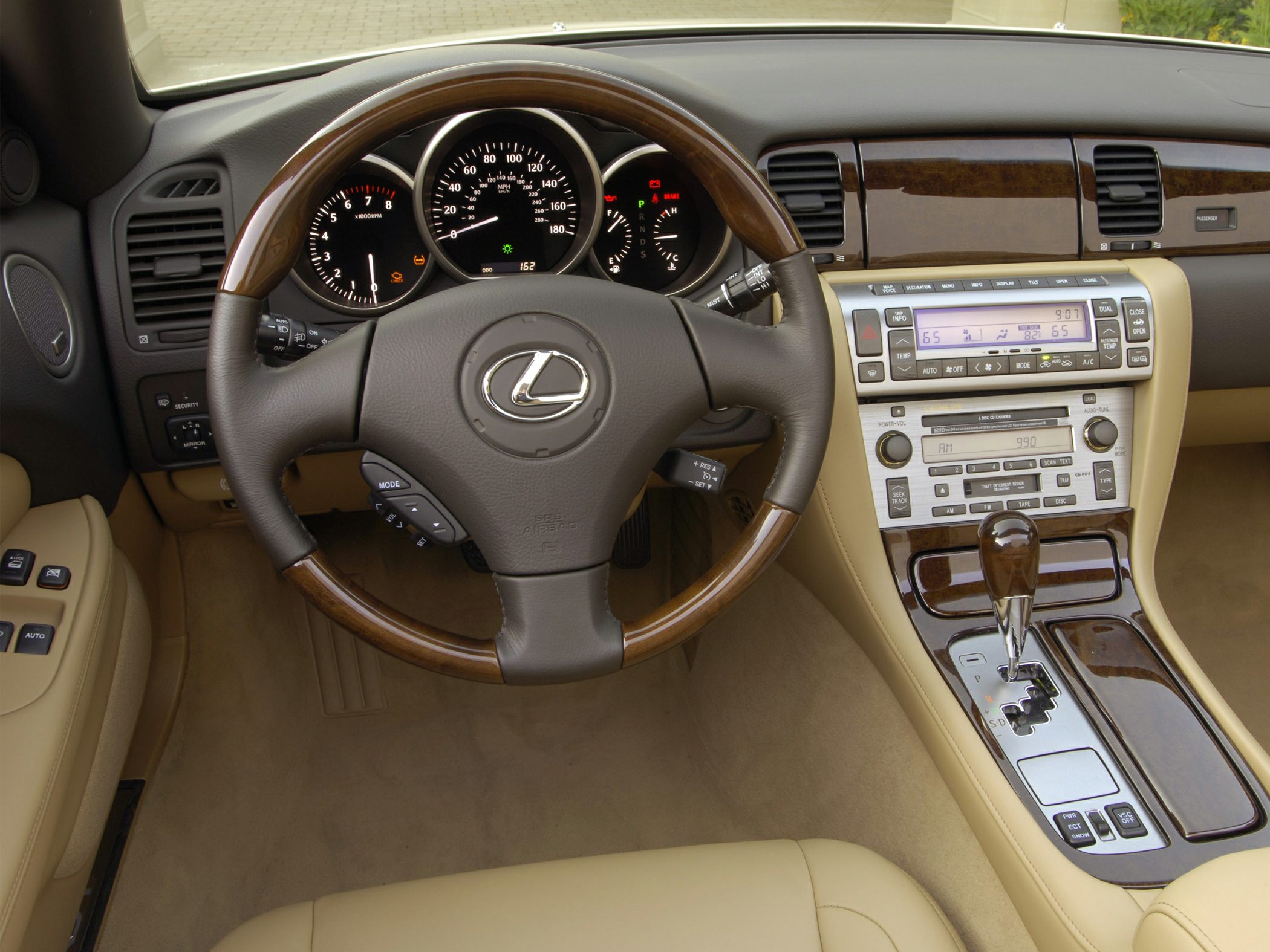 Wood-trimmed steering wheel with dashboard and center console controls
