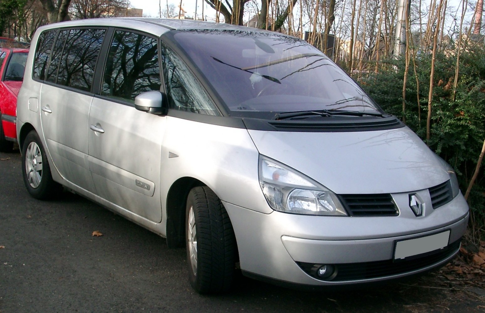 Silver minivan with angled headlights and large windshield