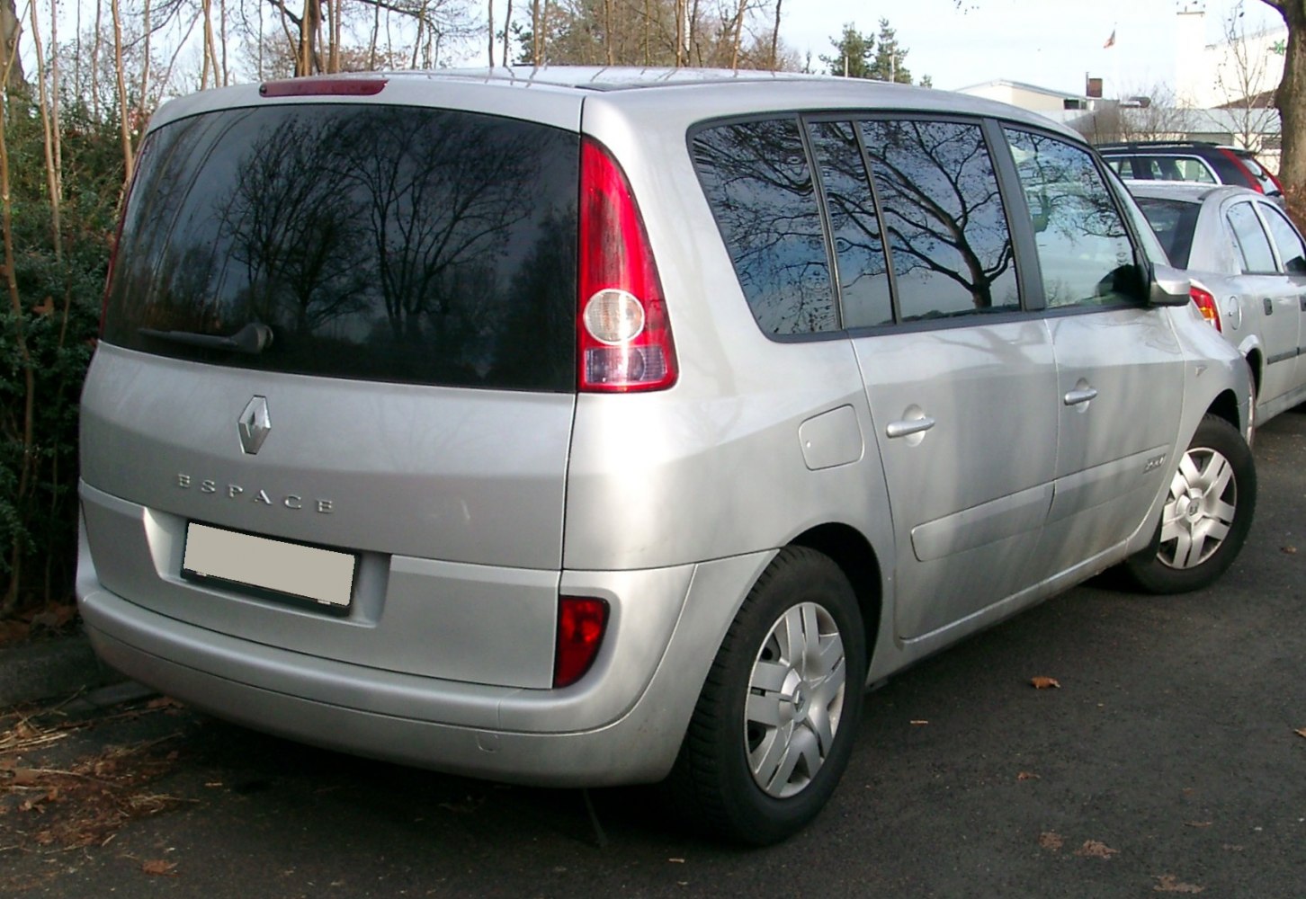 Rear and side view with tall vertical taillights and wide tinted side windows