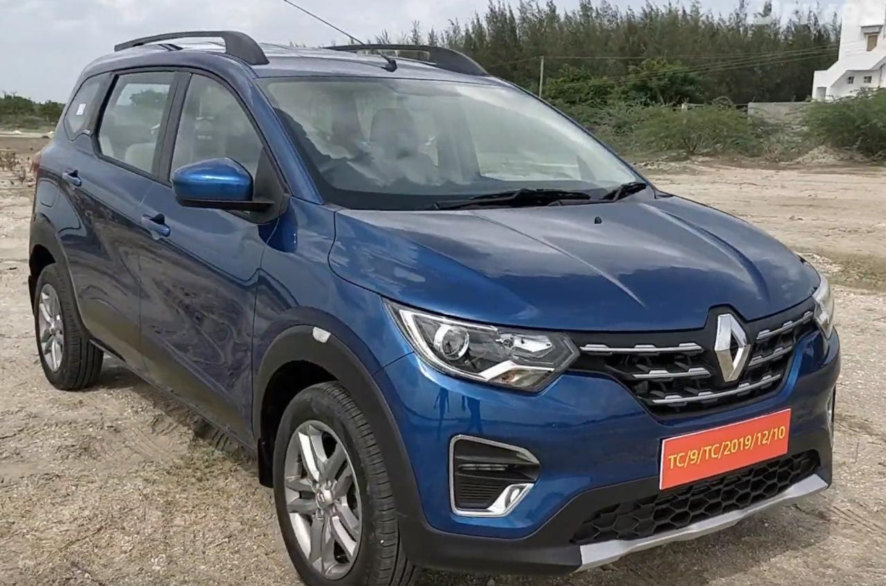 Front view of a blue compact SUV with LED headlights and grille.