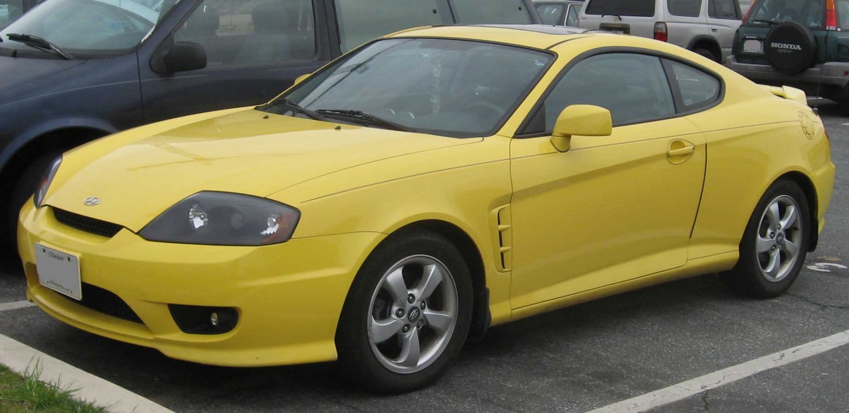 Yellow sporty coupe with front fog lights and alloy wheels
