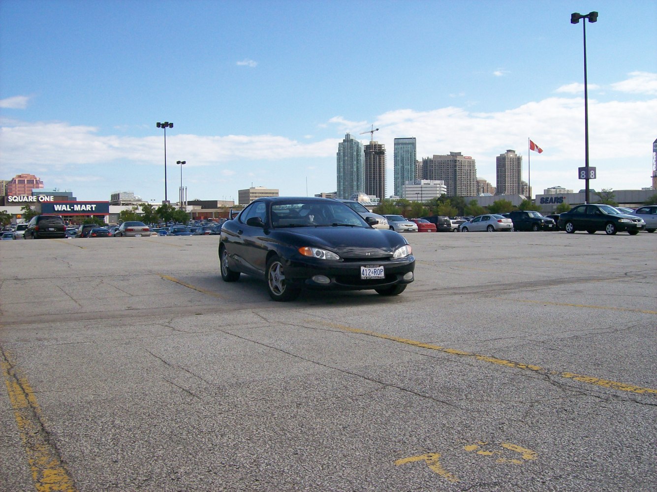 Front view of black coupe with distinctive headlights