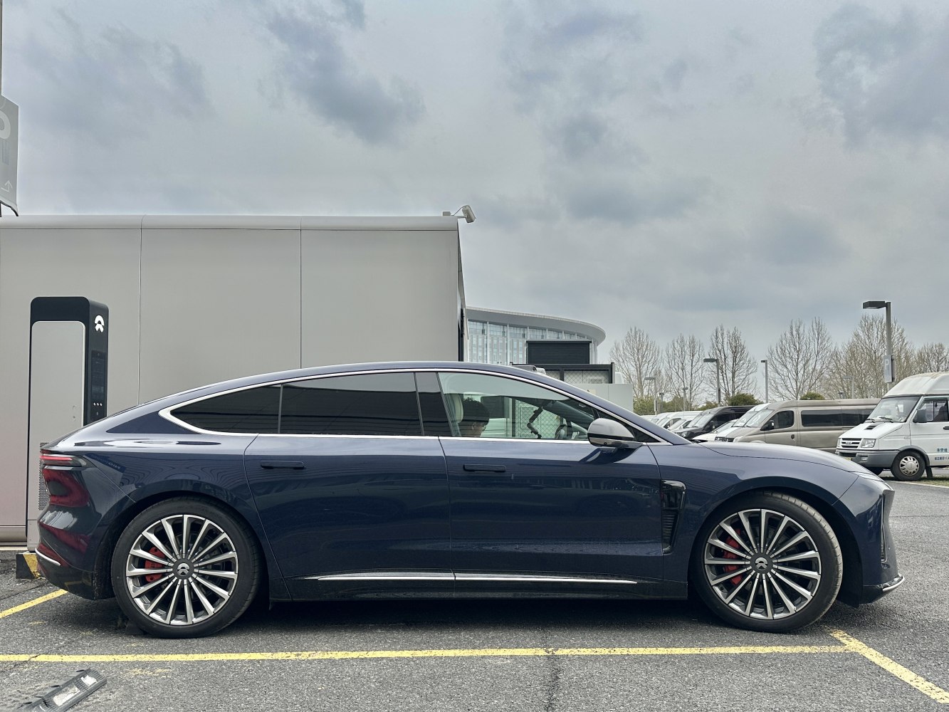 Sleek electric sedan with aerodynamic profile and multi-spoke alloy wheels