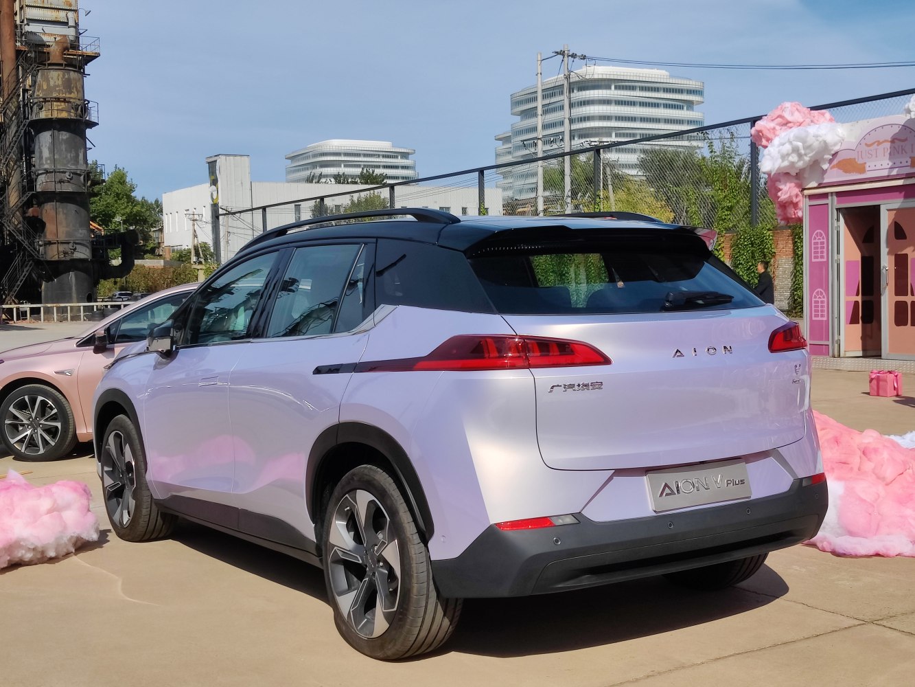 Rear view with sleek tail lights and black roof design