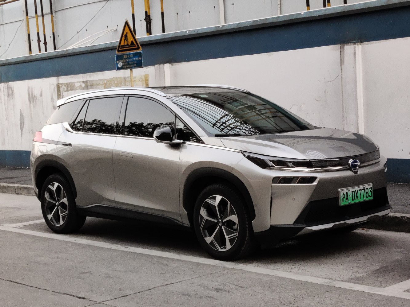 Sleek silver electric SUV with aerodynamic shape and LED headlights