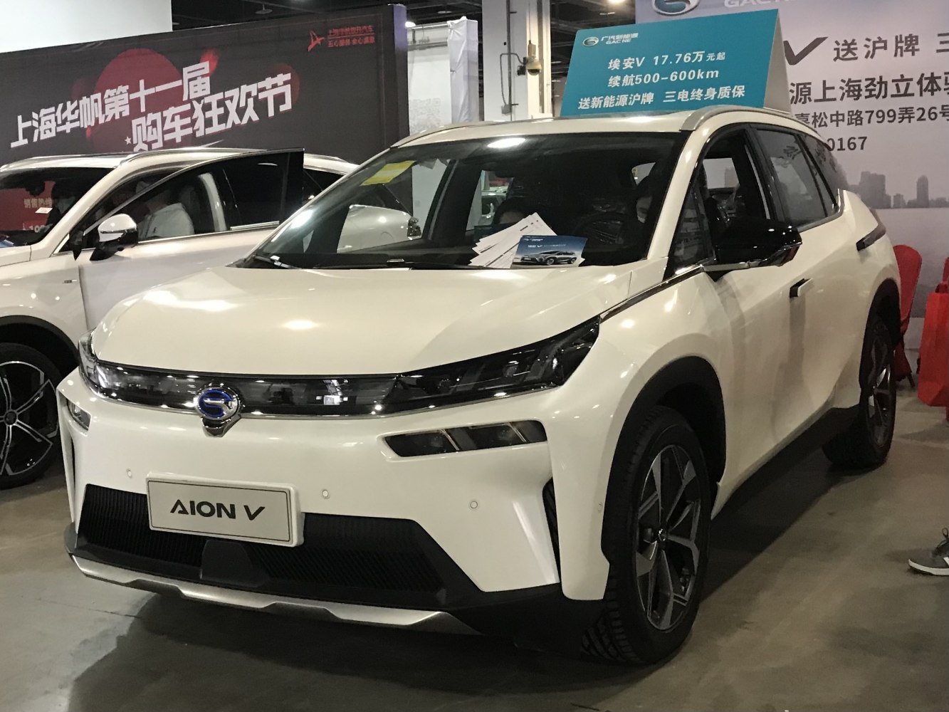 Futuristic LED headlights and sleek white electric SUV body
